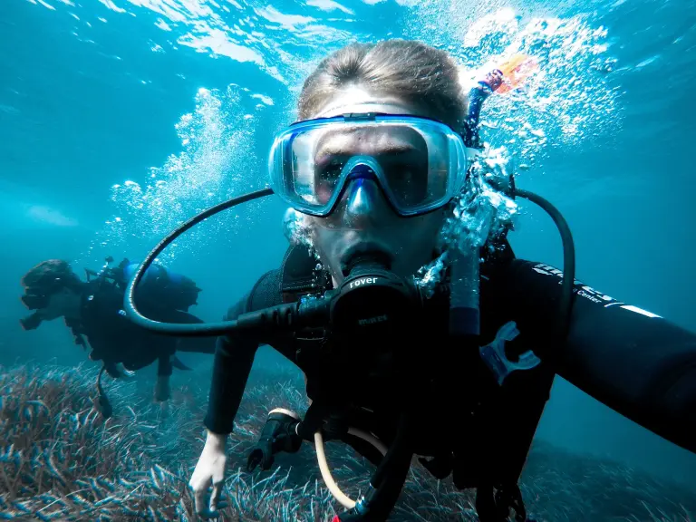 Man scuba diver and beautiful colorful coral reef underwater.