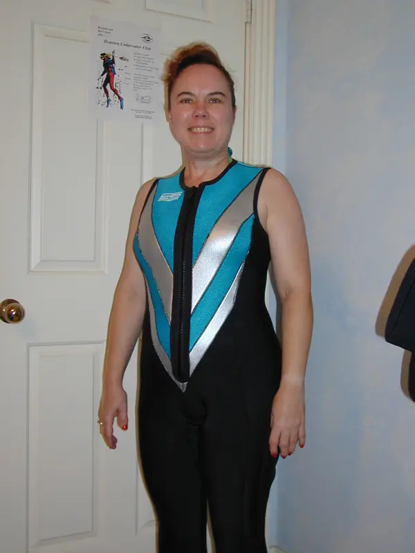 A Lady In The Black And Blue Colored Neoprene Wetsuits